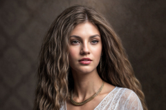 the_image_features_a_woman_with_long_wavy_hair_wearing_a_sheer_white_lace_kaftan_and_a_statement_nec_4a3f13a3-e37b-4a10-8866-eaafe3cf9e0b